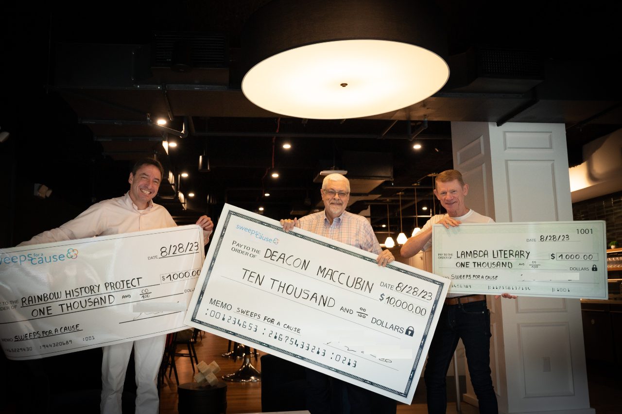 Deacon Maccubbin with the Rainbow History Project and Lambda Literary representatives holding their winning checks